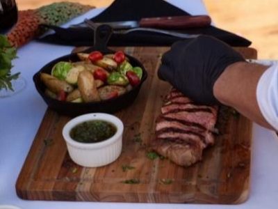 Chef carving steak at a live station
