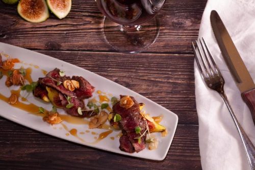 Plated entrée with figs and red wine